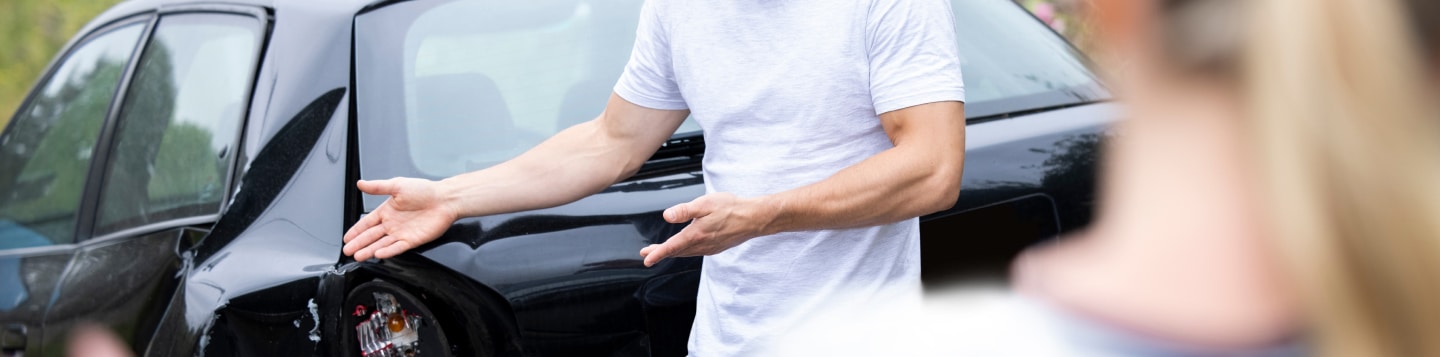 Image of two people who have gotten into a car accident.