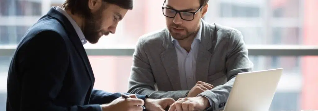 A lawyer going through paperwork with his client.