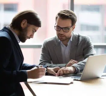 A lawyer going through paperwork with his client.