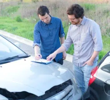 Two drivers exchange contact information following an accident