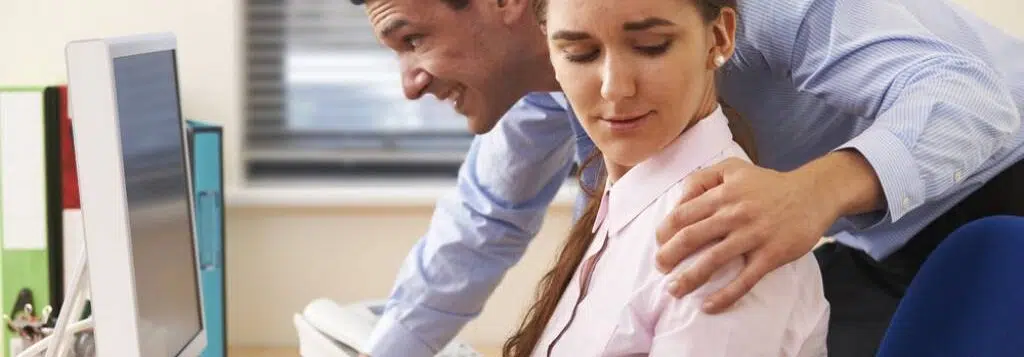 A businessman with his hand on an uncomfortable girl’s shoulder.