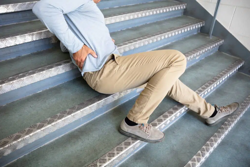Man at work who slipped on poorly constructed staircase